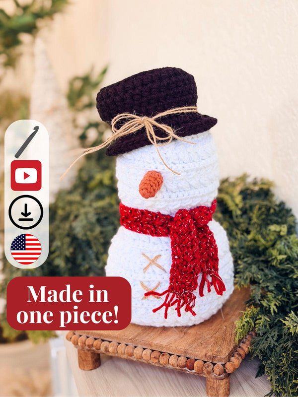 Wheat Stitch Christmas Set crochet patterns: white crochet snowman with a brown top hat, red scarf and carrot nose on a wooden riser