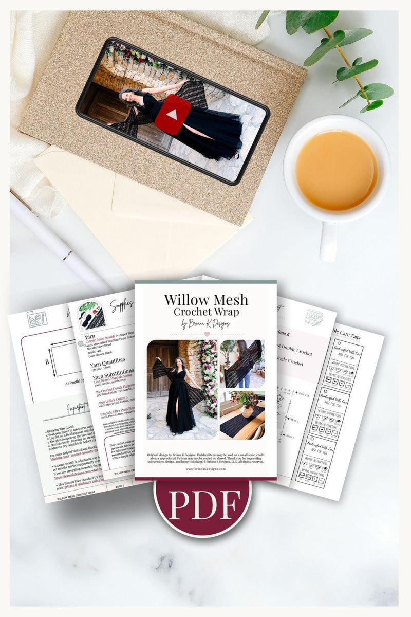 Pattern PDF pages and a phone showing the video tutorial, with a cup of tea on a marble surface
