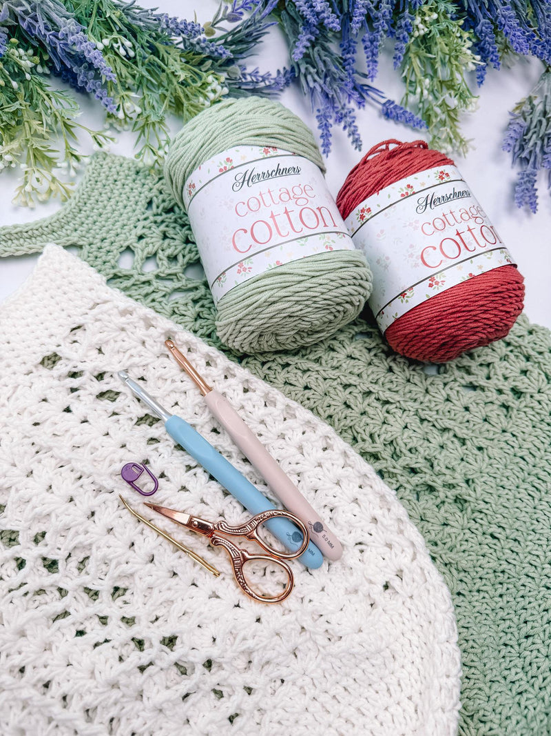 Cotton yarn in sage and terracotta with crochet hooks for the Willow Mesh market bag