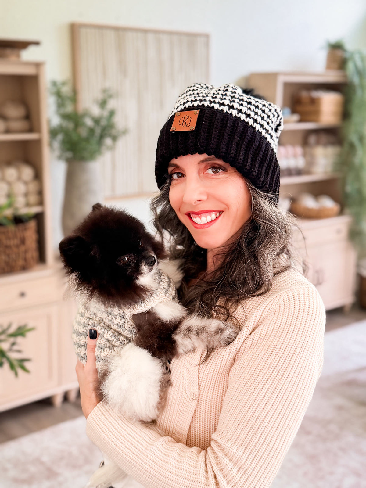 Briana and her dog in matching houndstooth crochet beanie and dog sweater
