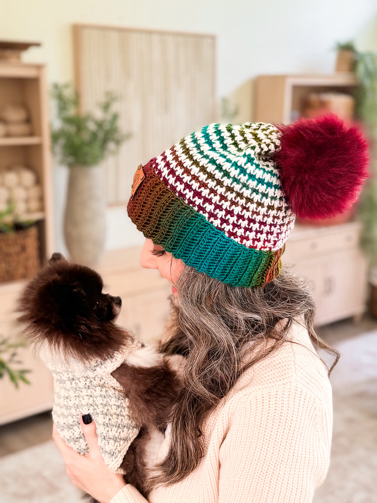 Briana and her dog in matching houndstooth crochet beanie and dog sweater