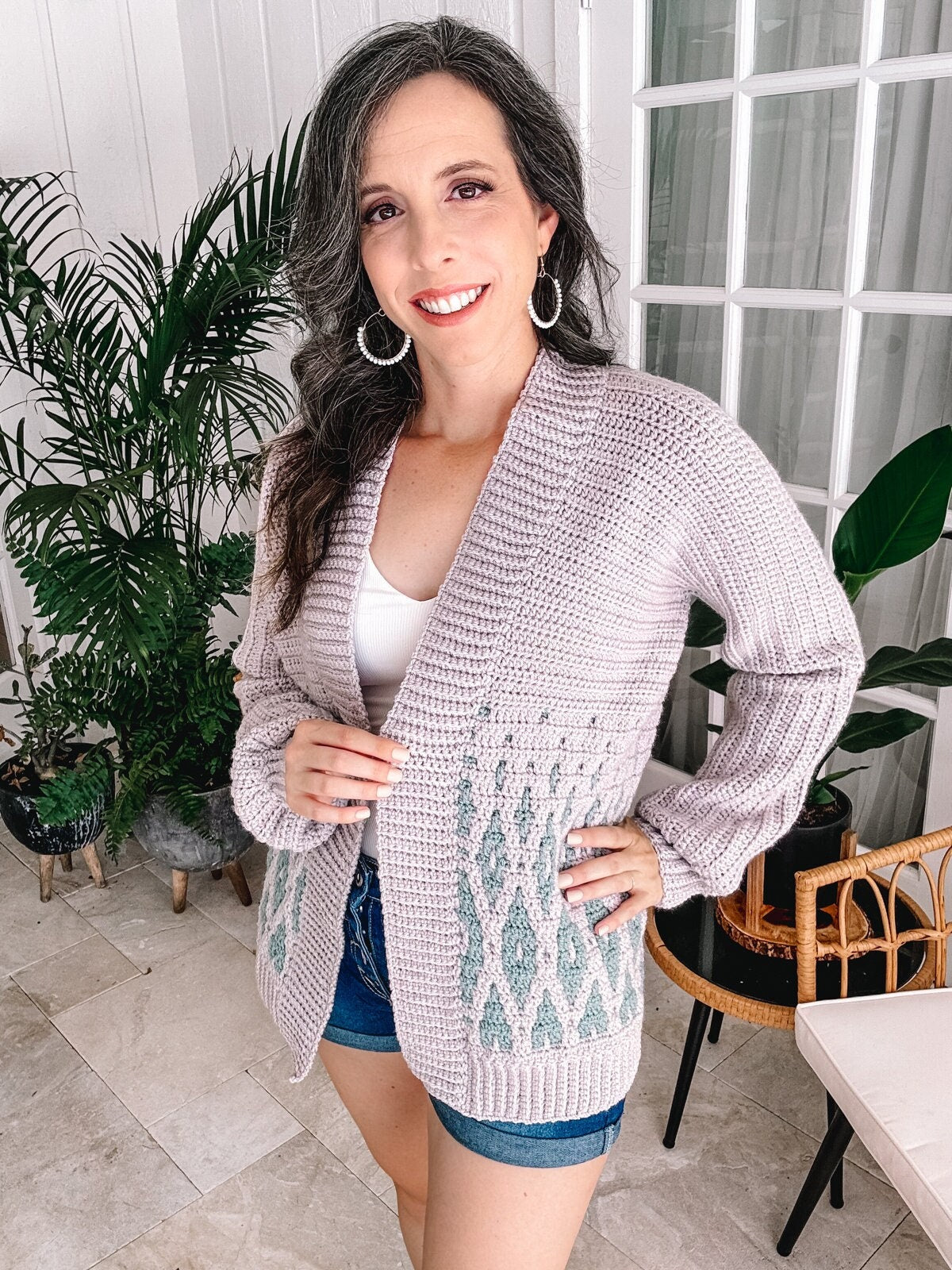A woman posing for a picture in crochet clothes.
