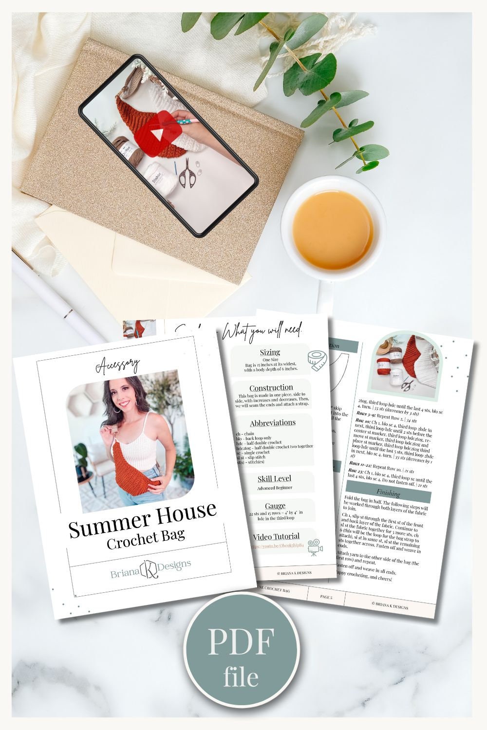 Image of a crochet bag project displayed on a tablet, a printed pattern, yarn, a cup of tea, and a potted plant on a light surface. Text reads “Summer House Crochet Bag” and “PDF file.” An ideal handmade gift for any occasion.