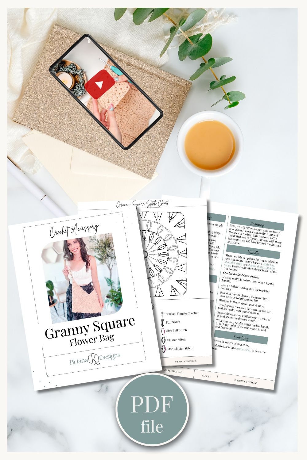 A flower bag pattern named "Granny Square Flower Bag" by Barbara Designs, with printed instructions, a notebook, a smartphone, and a cup of coffee on a table. Perfect as a handmade gift. PDF file icon included.