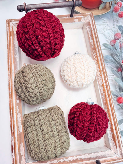 Displayed on a wooden tray, these five crocheted ornaments in red, green, and white make the perfect handmade gift.