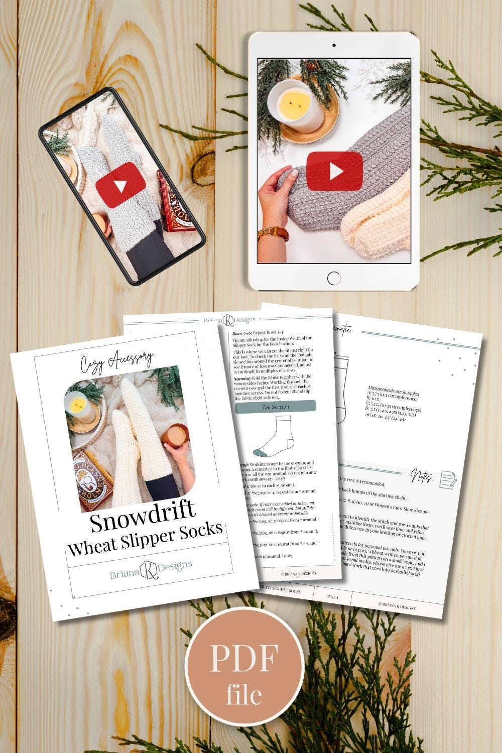 Flat lay of digital devices and printed pages showing crochet patterns and videos for Snowdrift Wheat Slipper Socks, surrounded by winter-themed decorations, making it the perfect setup for crafting a thoughtful handmade gift.