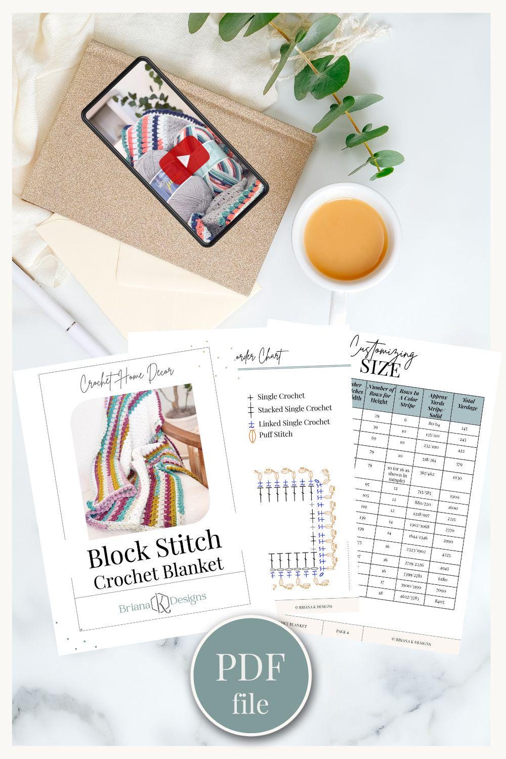 Crochet blanket pattern sheets, a tablet displaying a video, and a cup of coffee rest on the table alongside a PDF file. This handmade gift inspiration is perfect for those who appreciate the charm of crafting.