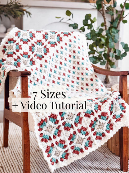 Windowpane Granny Blanket crochet pattern: cream crochet granny square blanket with red, teal, and tan motifs on a wooden chair, with 7 sizes and video text