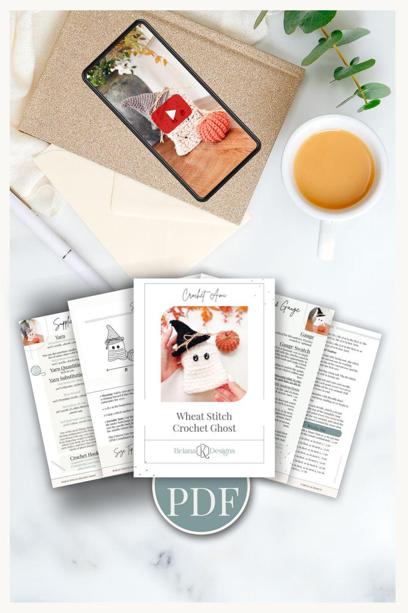 Flat lay of a crochet ghost pattern PDF, printed instructions, a cup of coffee, a plant, a phone with a crochet ghost photo, and an envelope—perfect inspiration for your next handmade gift.