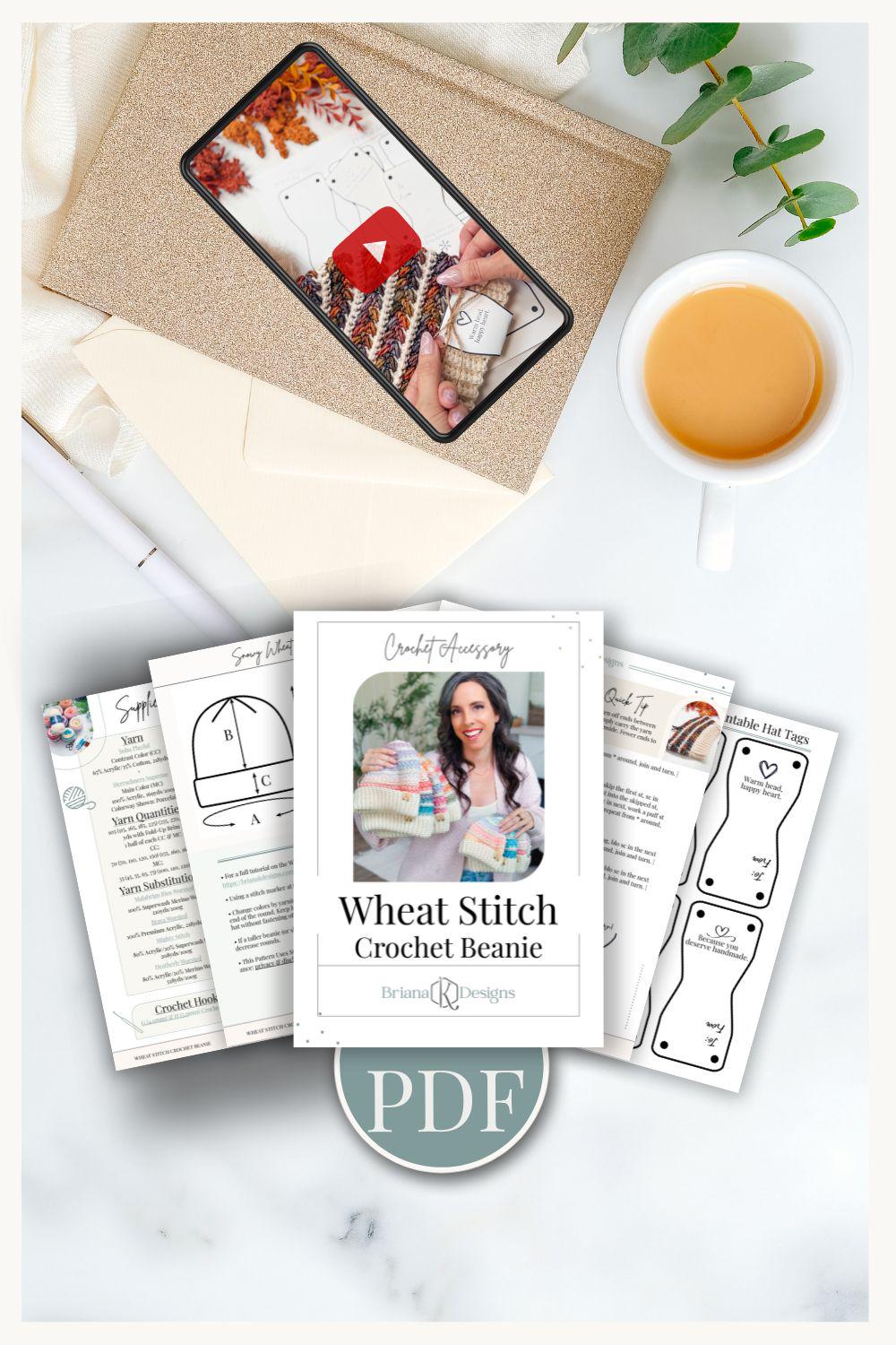 Flat lay of a crochet beanie pattern set, perfect for crafting a handmade gift, featuring printed instructions, templates, a "PDF" label, a cup of tea, and a smartphone showing a crochet video tutorial.