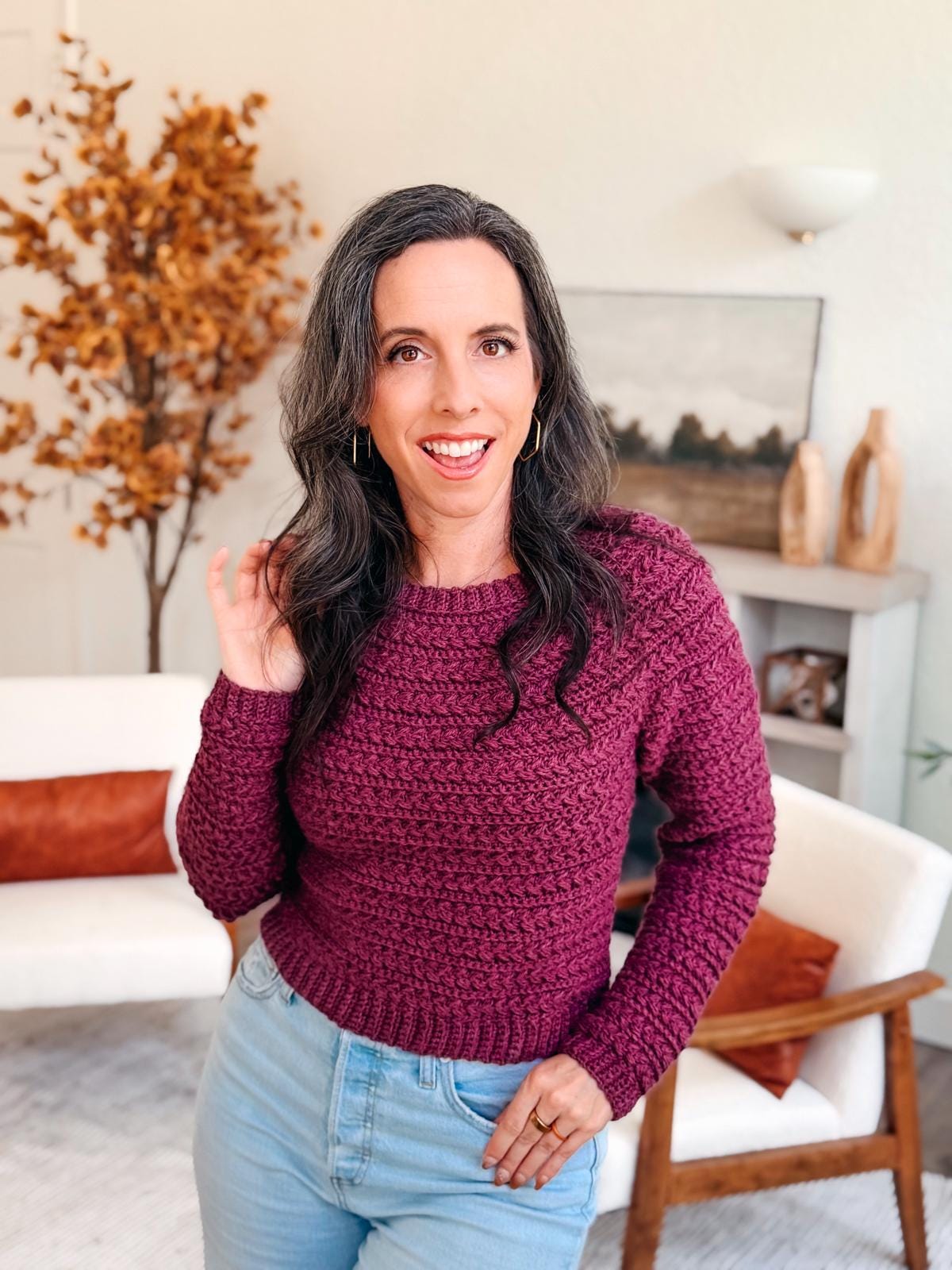 Handmade Wheat Stitch Sweater modeled in vibrant yarn tones; crochet pattern features 9 sizes, no sewing, and detailed sleeve shaping — ideal for cozy winter or fall crochet projects.