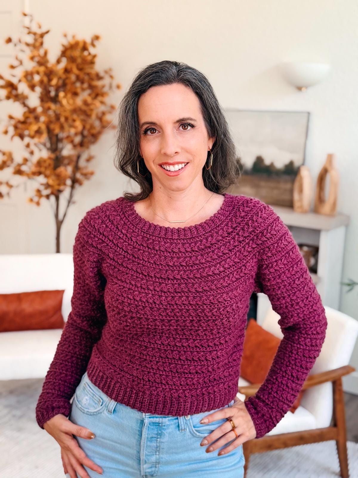Smiling woman models the Wheat Stitch Crochet Sweater, a colorful top-down crochet pattern available in 9 sizes with guided sleeve shaping — a cozy handmade gift idea for crocheters.