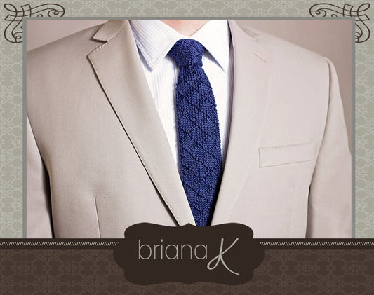 Navy crochet tie with a white shirt and beige suit, framed by a decorative border with the Briana K logo