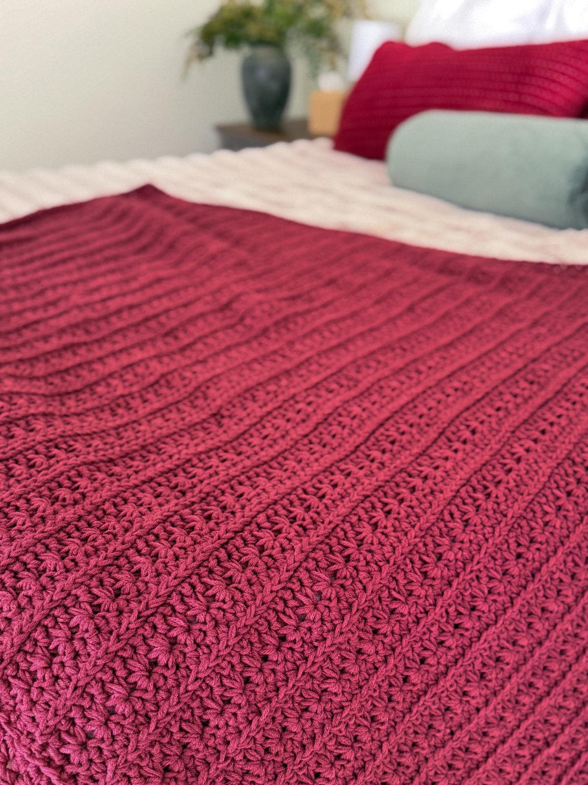Flat lay of the deep red Petal Loop Stitch crochet blanket texture