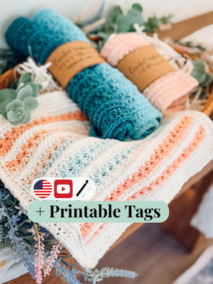 Striped cream crochet washcloth with rolled teal and peach cloths in a basket, with a printable tags banner