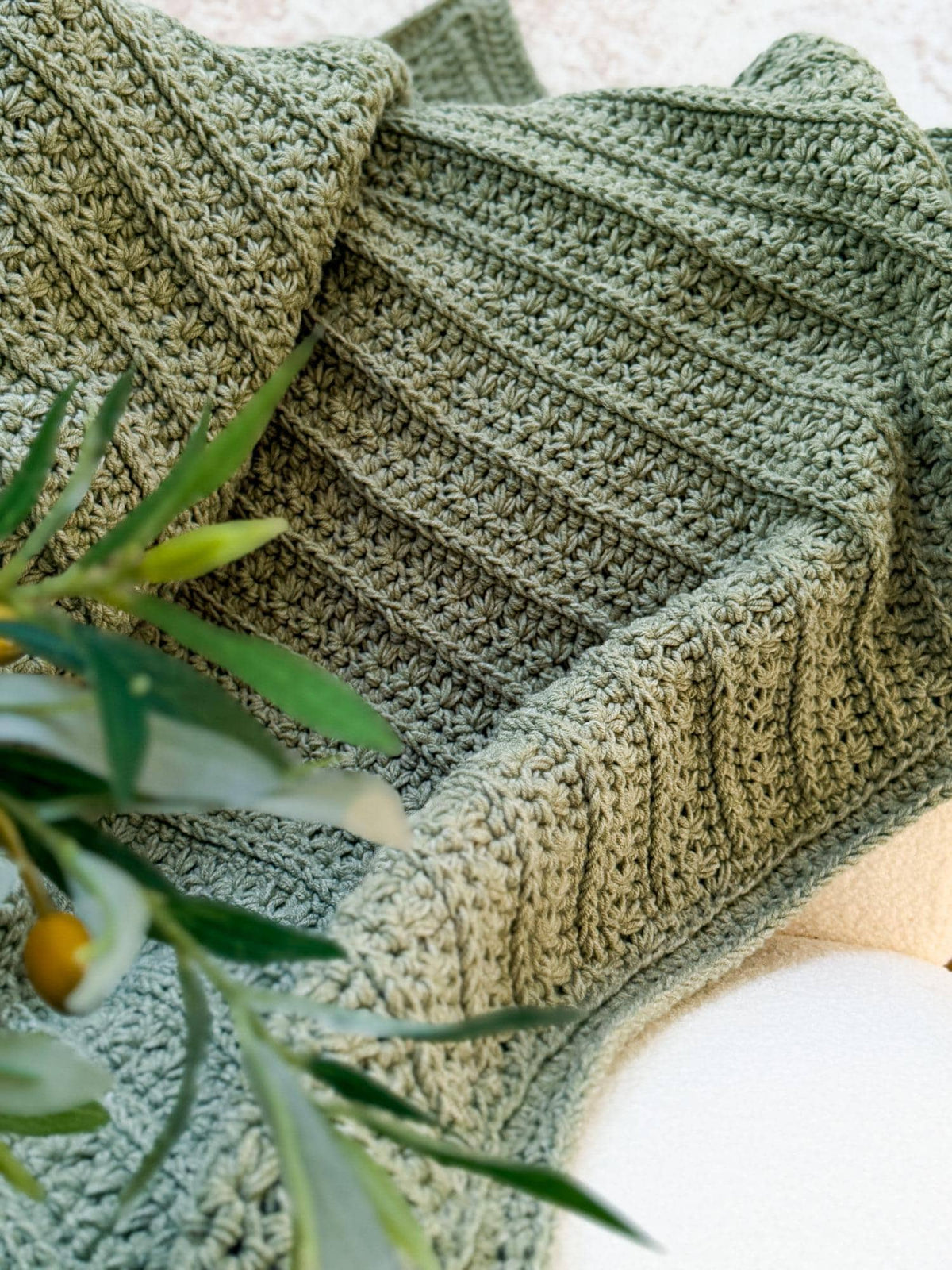Close up of the Petal Loop Stitch rows in sage green yarn