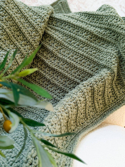Close up of the Petal Loop Stitch rows in sage green yarn