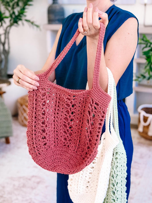 Willow Mesh crochet market bag in dusty rose worn on the shoulder