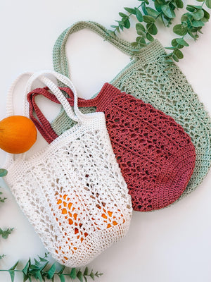 Three Willow Mesh crochet market bags in cream, dusty rose and sage with oranges