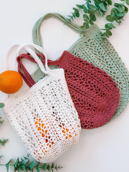 Three Willow Mesh crochet market bags in cream, dusty rose and sage with oranges