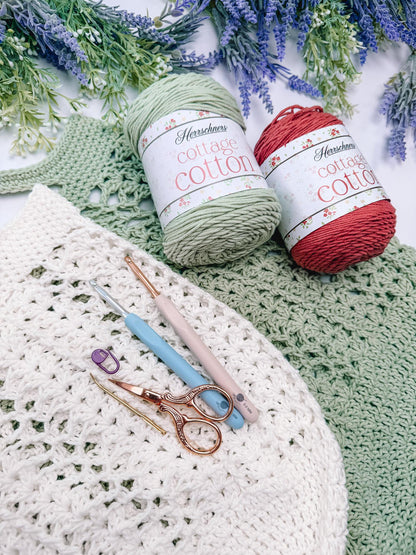 Cotton yarn in sage and terracotta with crochet hooks for the Willow Mesh market bag