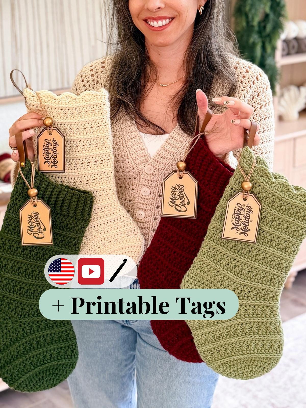 Woman holding crocheted stockings with printable tags, smiling.