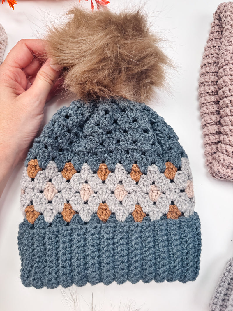 Gemstone Hues crochet beanie in blue with a faux fur pompom