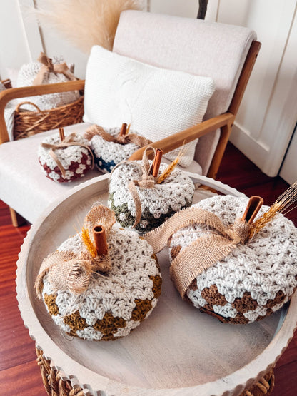 Diamond granny stitch crochet pumpkins on a tray
