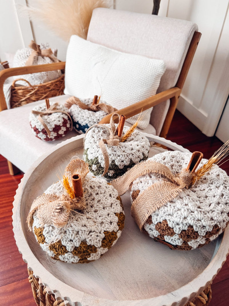 Diamond granny stitch crochet pumpkins on a tray