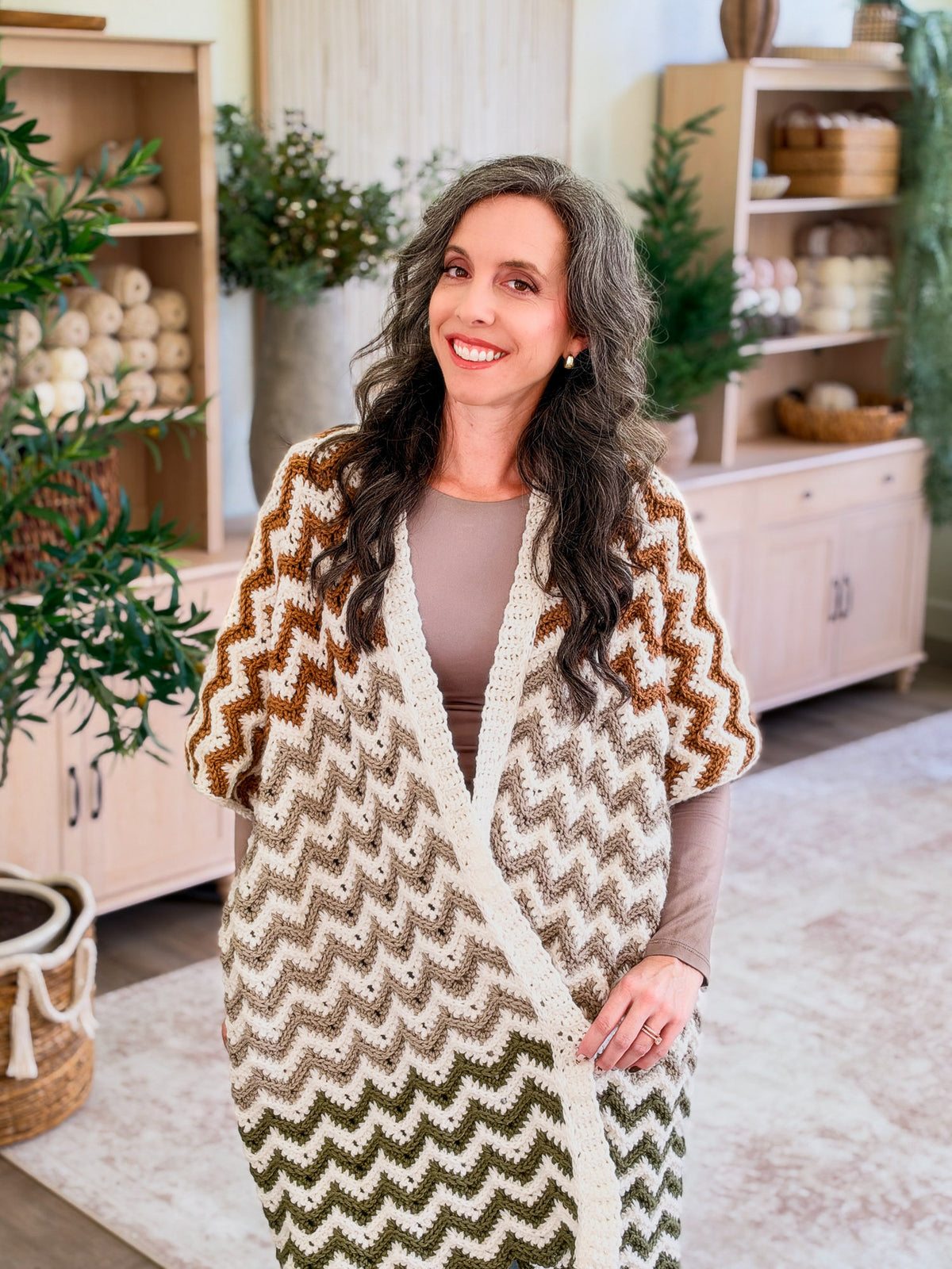 Close view of the Ripple Crochet Ruana stripes in camel, sand, and green